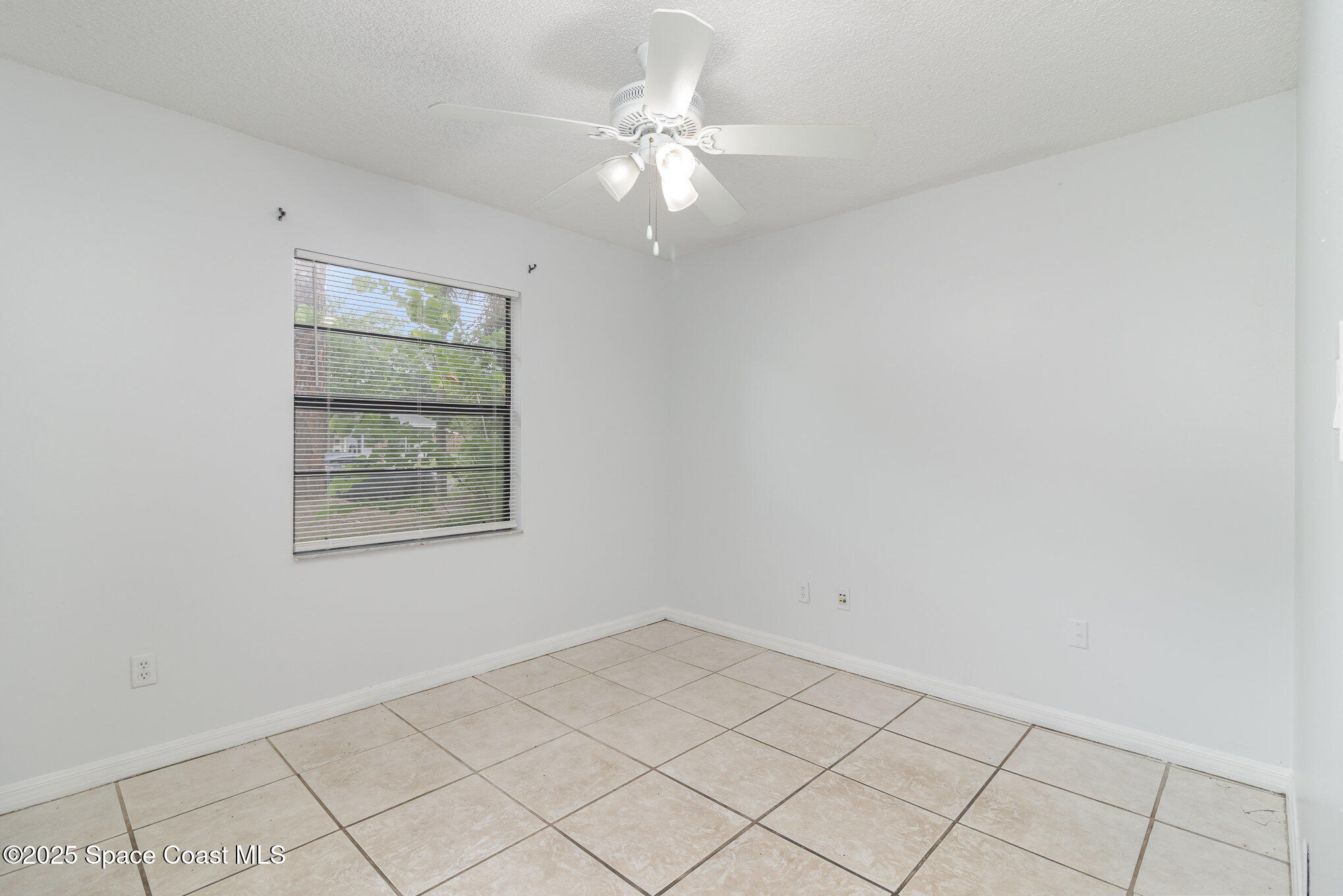 7413 Ester Road Cocoa, FL 32927 - Photo 15 of 30 an empty room with windows and fan