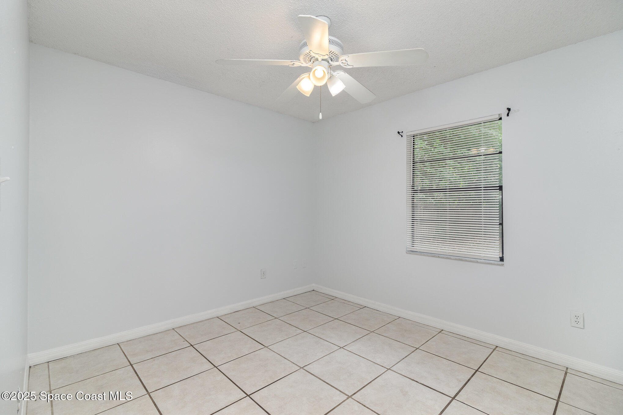 7413 Ester Road Cocoa, FL 32927 - Photo 17 of 30 wooden floor in an empty room with a window