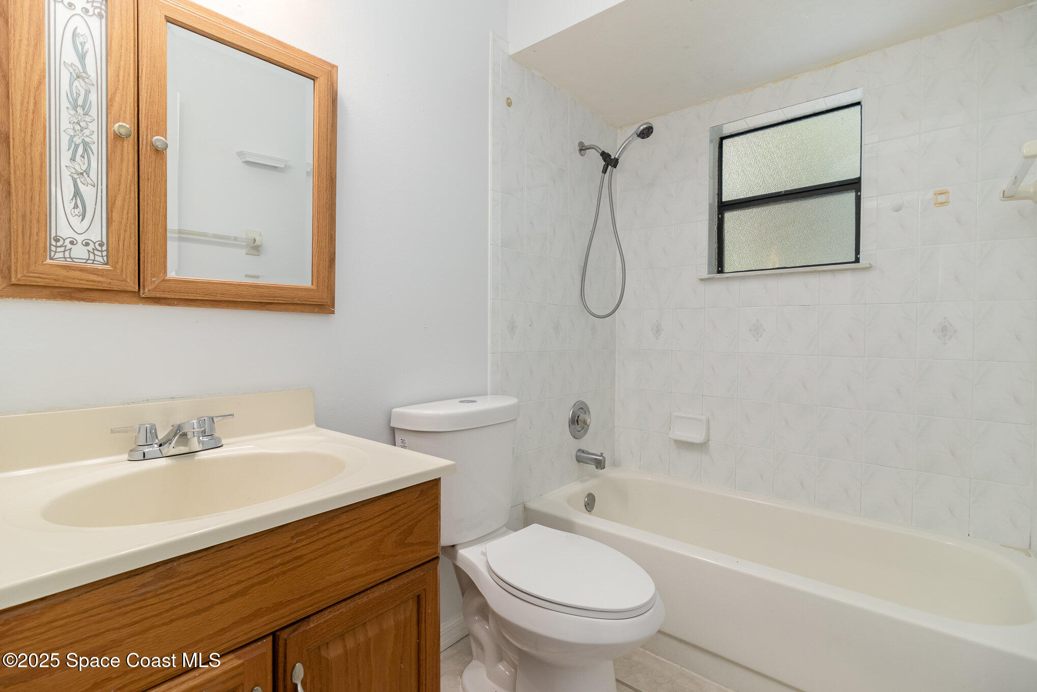 7413 Ester Road Cocoa, FL 32927 - Photo 19 of 30 a bathroom with a sink toilet and shower