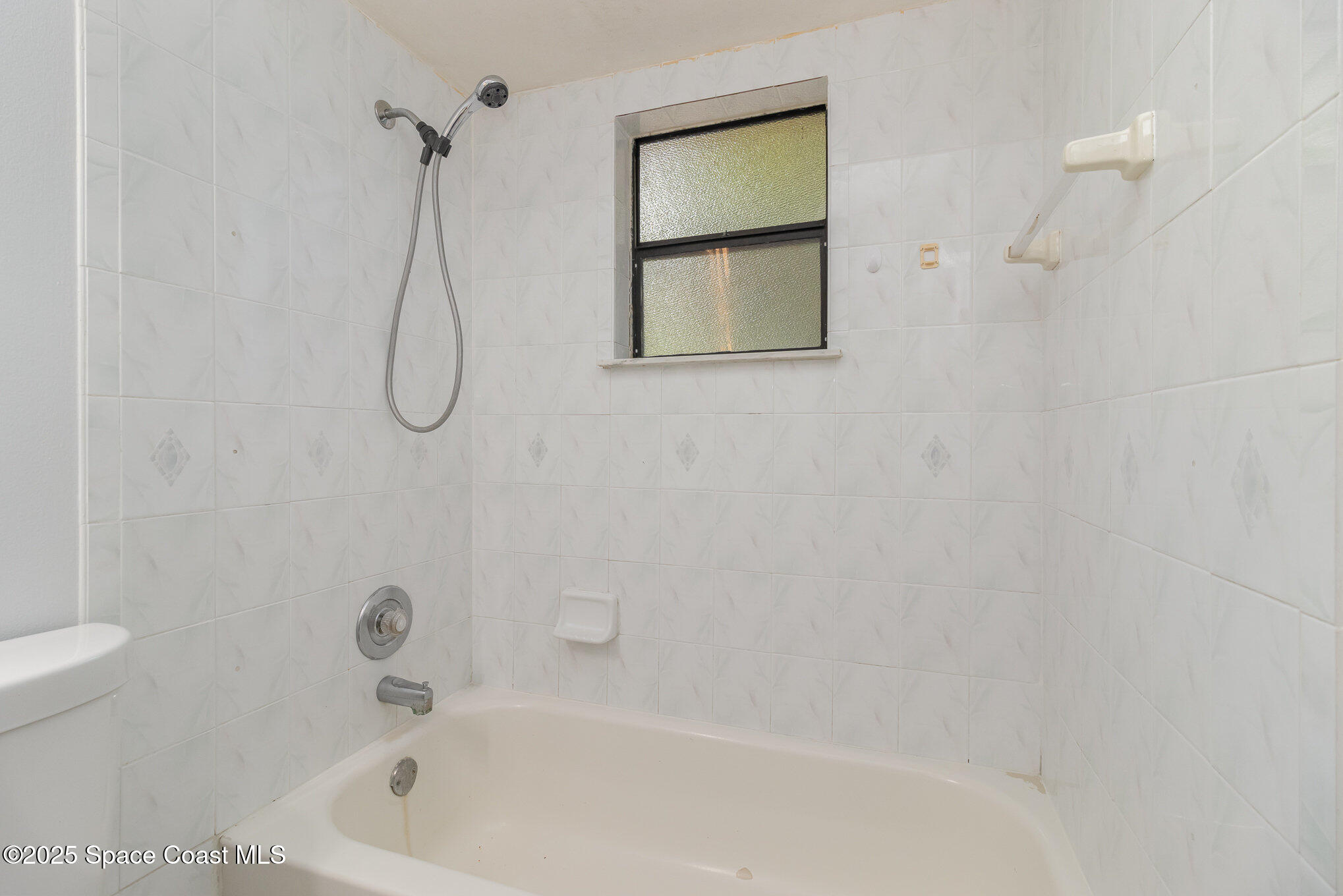 7413 Ester Road Cocoa, FL 32927 - Photo 20 of 30 a bathroom with a bath tub and a shower