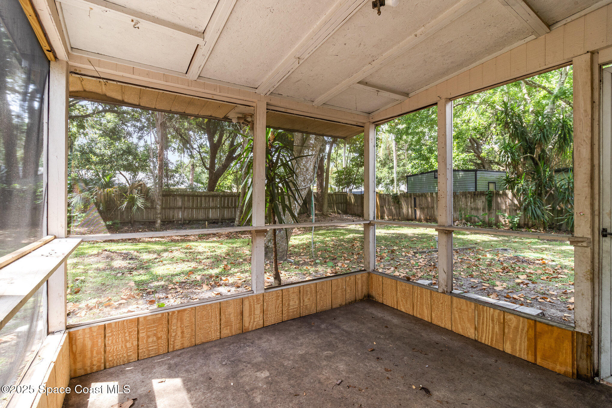 7413 Ester Road Cocoa, FL 32927 - Photo 22 of 30 a view of a porch with wooden floor and outside view