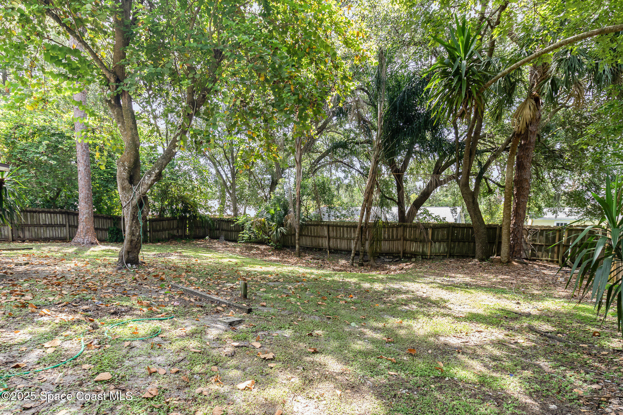 7413 Ester Road Cocoa, FL 32927 - Photo 23 of 30 a house with trees in front of it