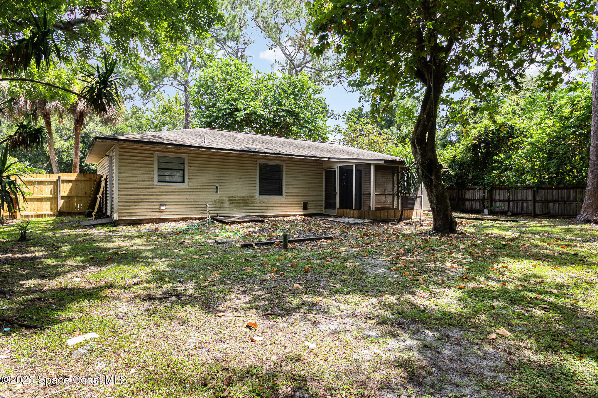 7413 Ester Road Cocoa, FL 32927 - Photo 24 of 30 a backyard of a house with barbeque oven