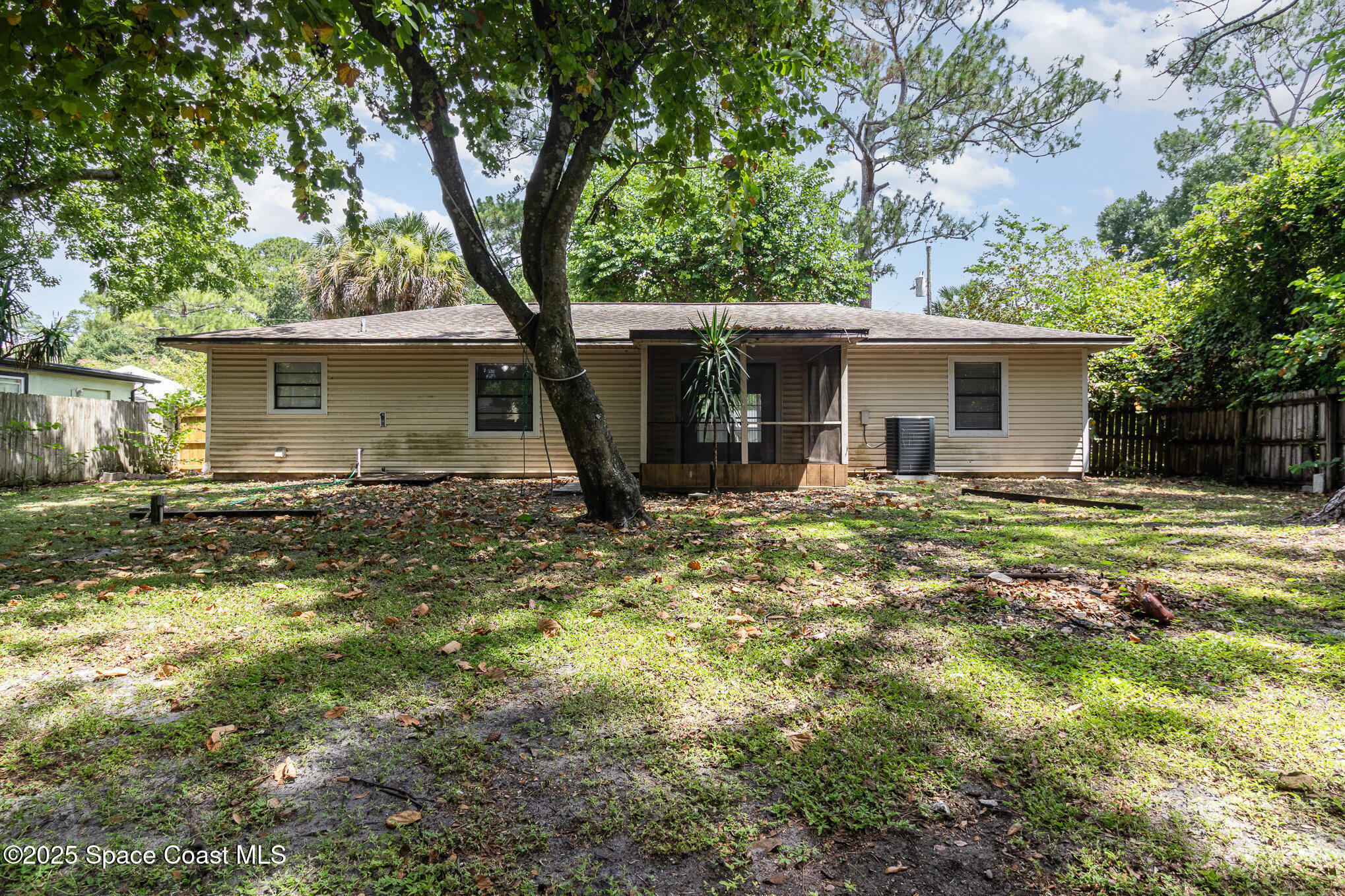 7413 Ester Road Cocoa, FL 32927 - Photo 25 of 30 a view of a house with a yard