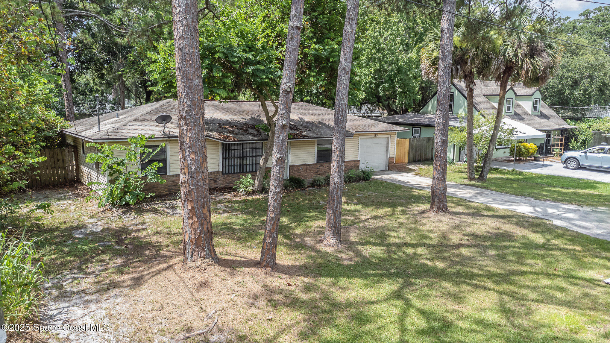 7413 Ester Road Cocoa, FL 32927 - Photo 26 of 30 a view of a house with a yard and large tree