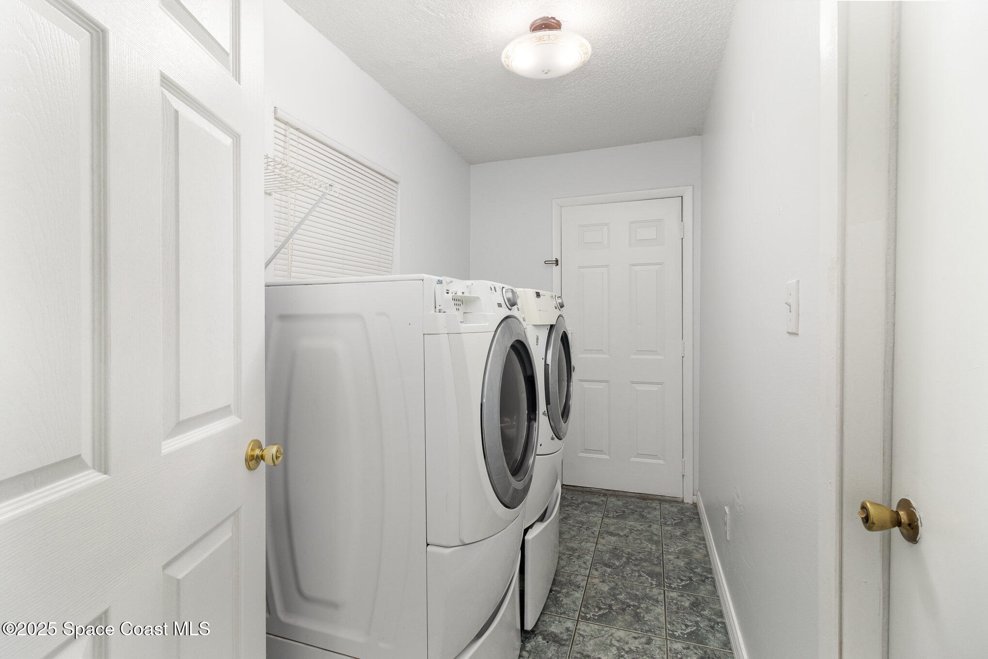 7413 Ester Road Cocoa, FL 32927 - Photo 10 of 30 a utility room with dryer and washer