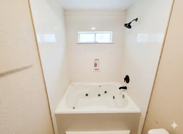 a bathroom with a bathtub and shower