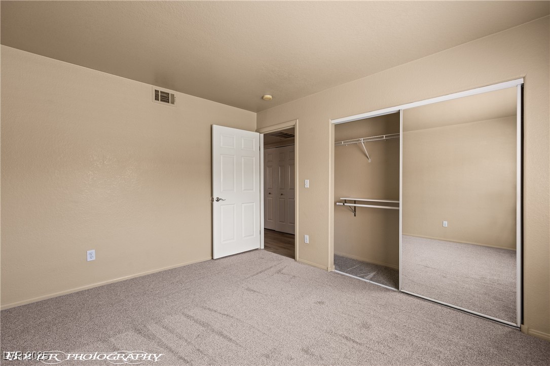 334 Colleen Court, Unit D Mesquite, NV 89027 - Photo 19 of 61 Unfurnished bedroom with carpet flooring and a closet
