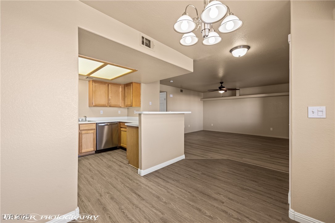 334 Colleen Court, Unit D Mesquite, NV 89027 - Photo 5 of 61 Kitchen with light countertops, light wood-type flooring, ceiling fan, stainless steel dishwasher, and a chandelier