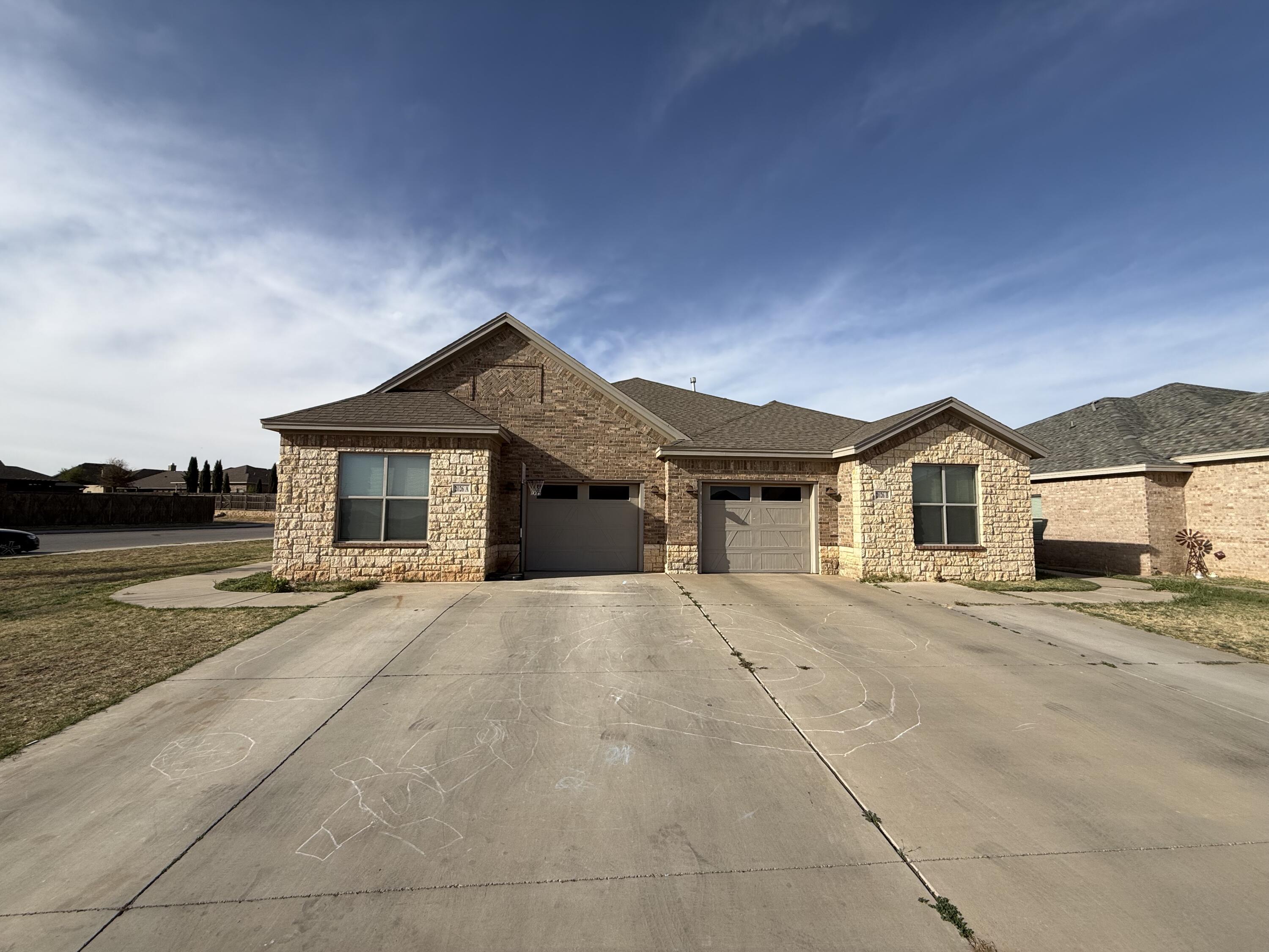 2026 102nd Street Lubbock, TX 79423 - Photo 1 of 16 front view of a house with a street