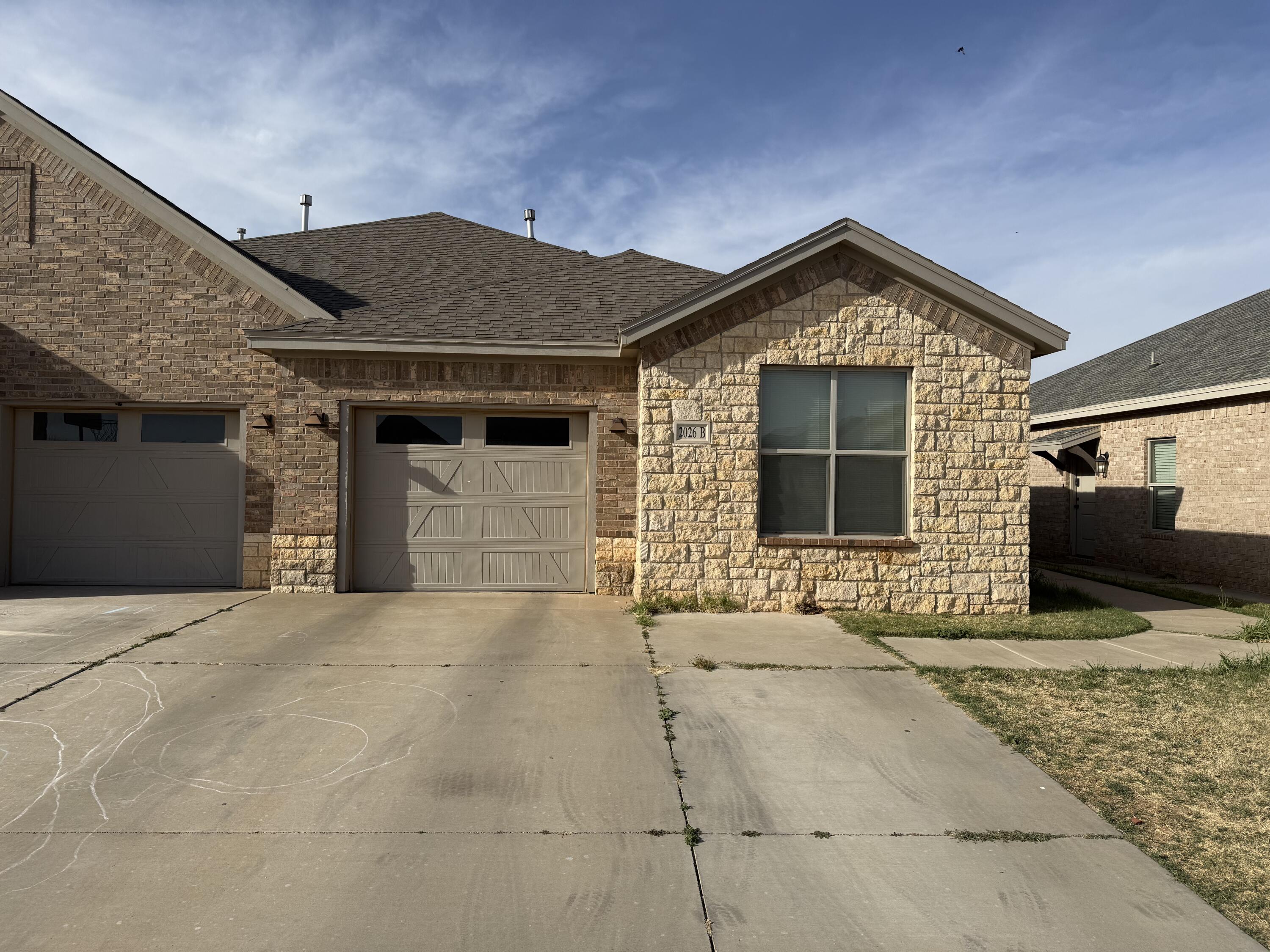 2026 102nd Street Lubbock, TX 79423 - Photo 5 of 16 a front view of a house with garage