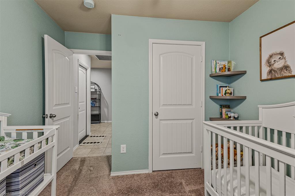 2440 Willard Way Forney, TX 75126 - Photo 17 of 25 a view of a bedroom with baby crib and toys