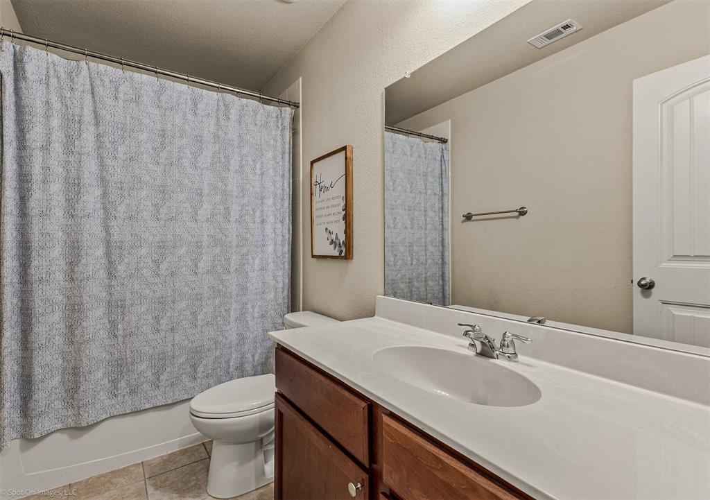 2440 Willard Way Forney, TX 75126 - Photo 20 of 25 a bathroom with a granite countertop sink toilet and a mirror
