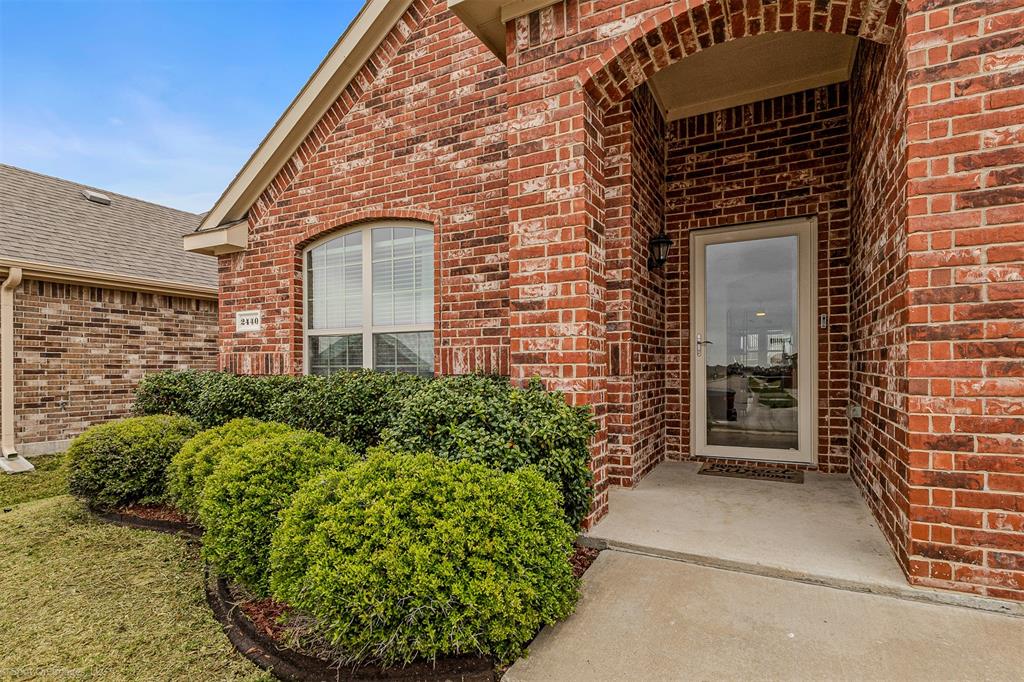 2440 Willard Way Forney, TX 75126 - Photo 2 of 25 front view of a brick house with a large window