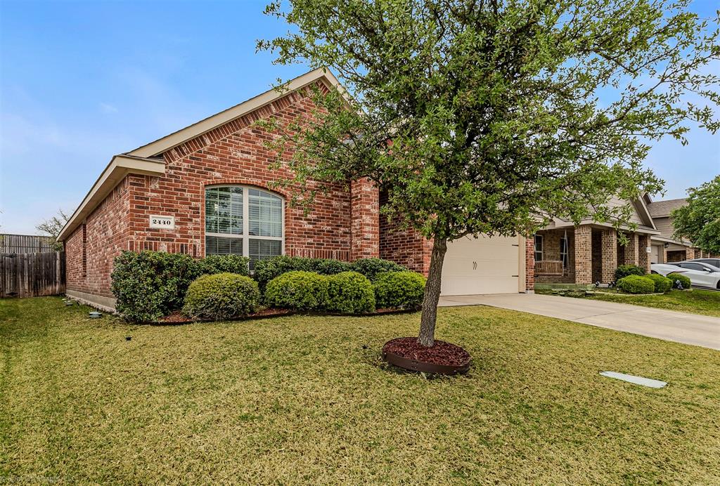2440 Willard Way Forney, TX 75126 - Photo 3 of 25 a front view of a house with a yard and garage