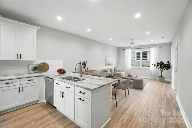 a kitchen with white cabinets stainless steel appliances and sink