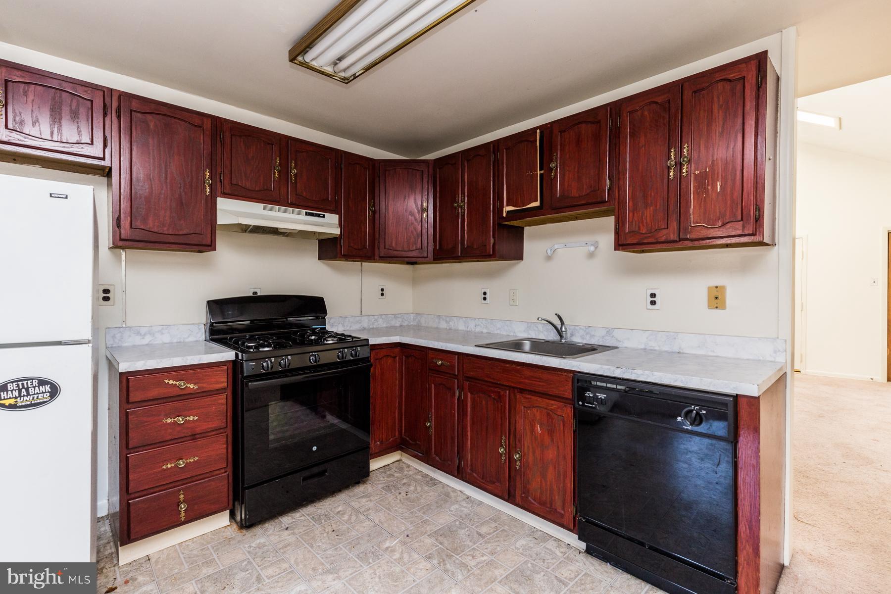 a kitchen with granite countertop wooden cabinets and stainless steel appliances