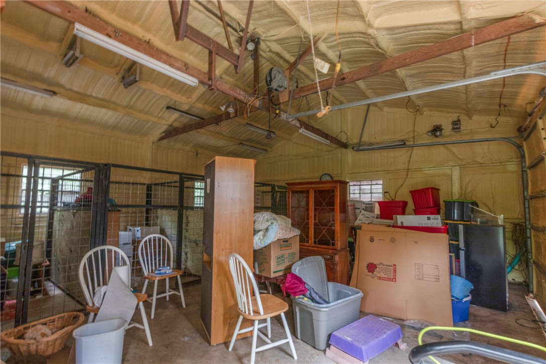 9997 Calhoun Road Bryan, TX 77808 - Photo 33 of 50 a storage room with lots of furniture and a chandelier