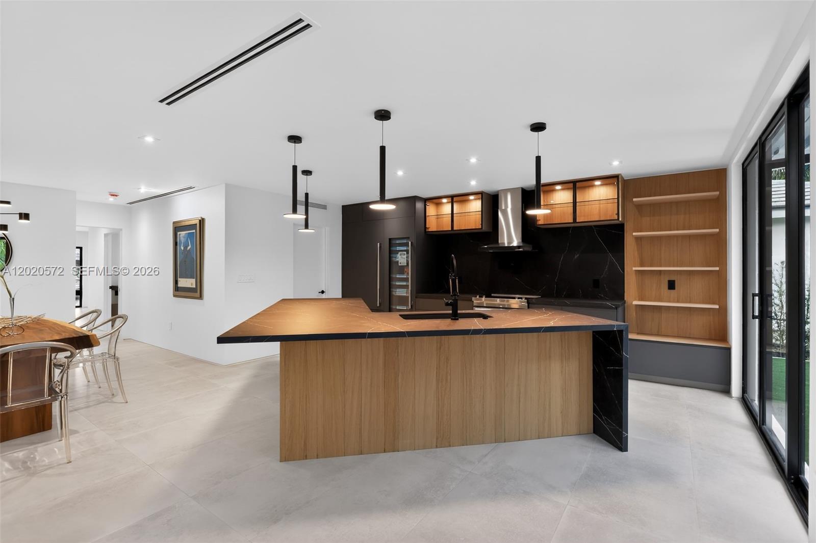 439 Hardee Road Coral Gables, FL 33146 - Photo 11 of 35 a kitchen with stainless steel appliances kitchen island a refrigerator and a sink