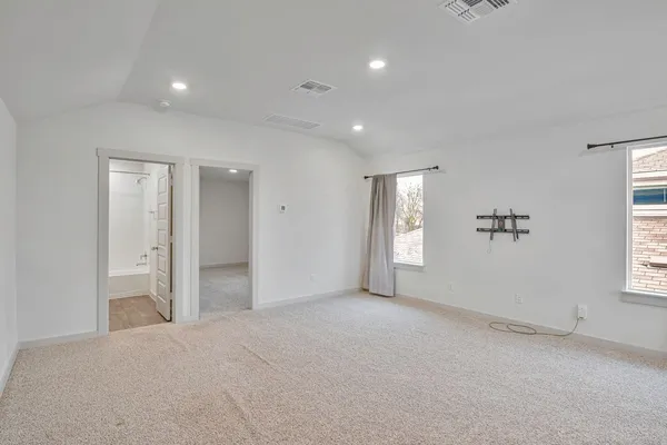 an empty room with windows and closet