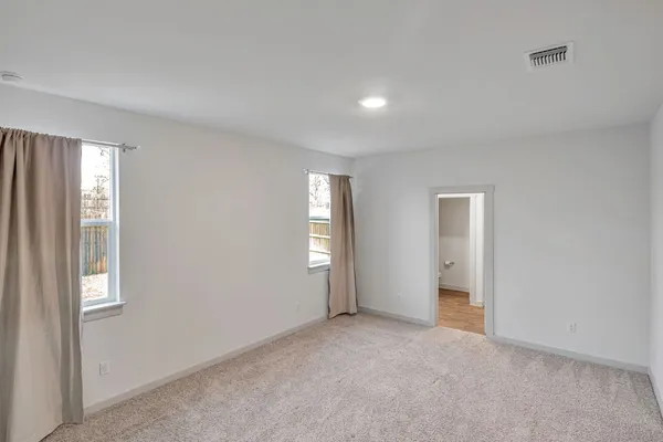a bathroom with a shower and a glass door