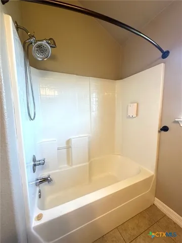 a bathroom with a tub and a shower