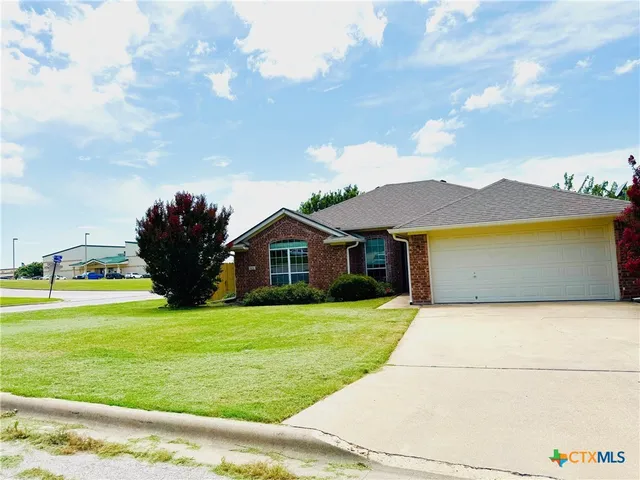a front view of a house with yard