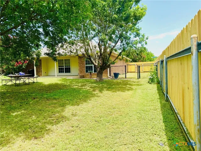 a house view with swimming pool in front of it
