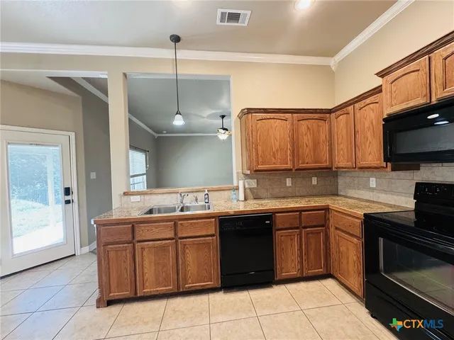 a kitchen with a sink a stove and cabinets