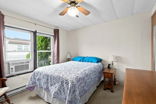 a bedroom with a bed and a large window