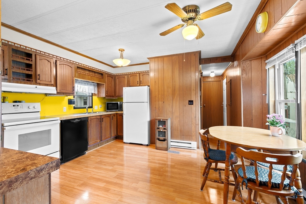 28 Dot's Lane Wareham, MA 02558 - Photo 8 of 25 a kitchen with stainless steel appliances kitchen island granite countertop a table chairs and a refrigerator