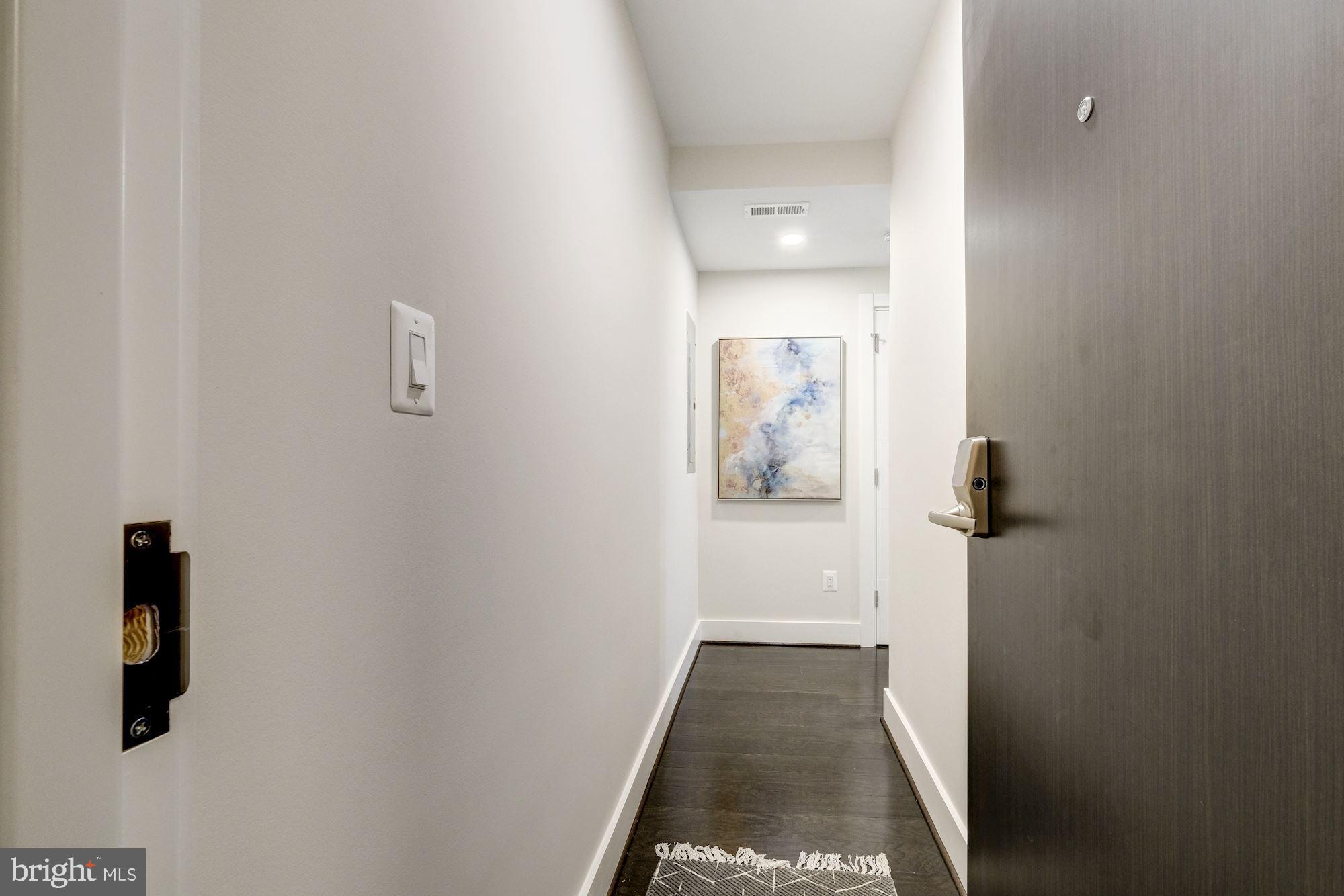 1331 K Street Southeast, Unit 302 Washington, DC 20003 - Photo 2 of 13 a view of a hallway with wooden floor and closet