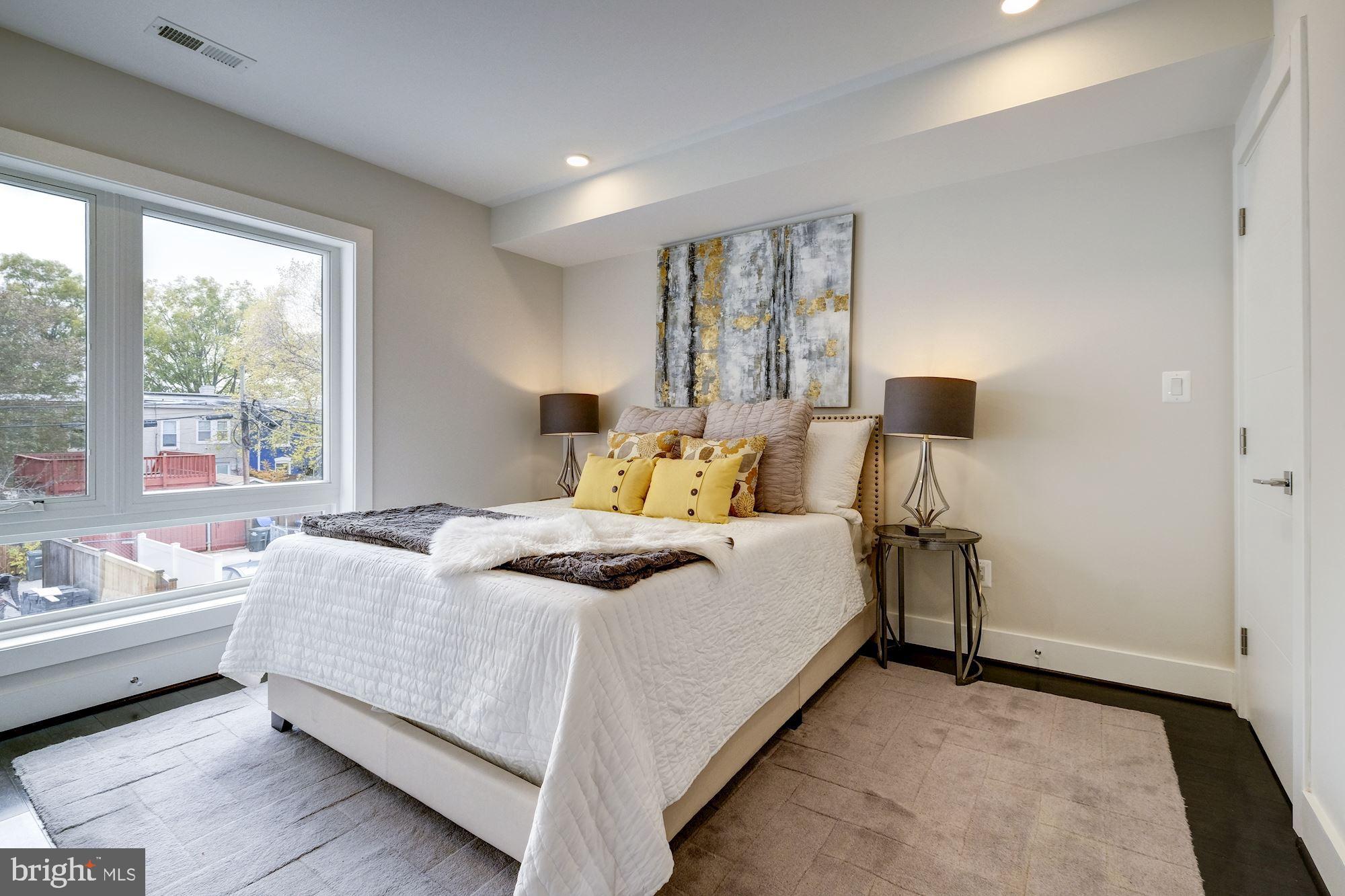 1331 K Street Southeast, Unit 302 Washington, DC 20003 - Photo 4 of 13 a bedroom with a bed and wooden floor