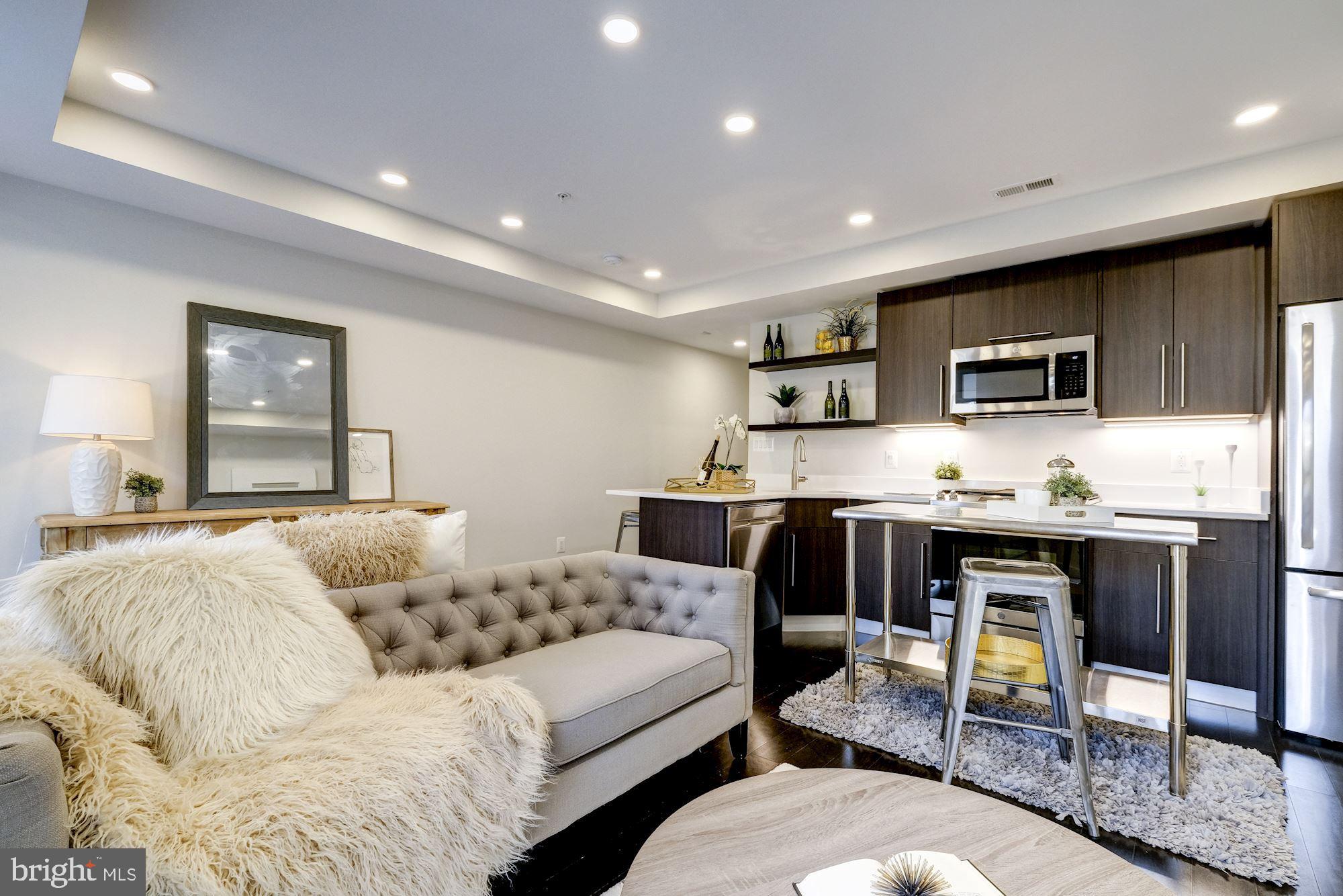 1331 K Street Southeast, Unit 302 Washington, DC 20003 - Photo 13 of 13 a living room with stainless steel appliances kitchen island granite countertop furniture and a kitchen view