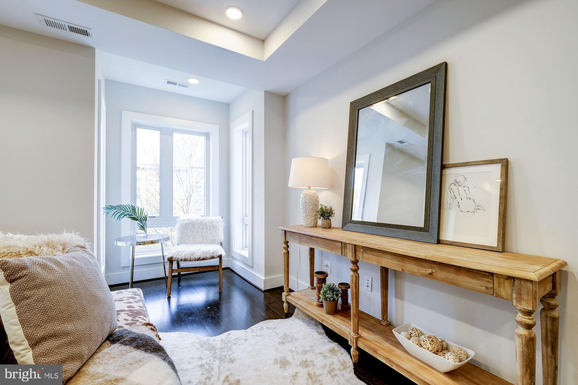 1331 K Street Southeast, Unit 302 Washington, DC 20003 - Photo 9 of 13 a living room with furniture and a window