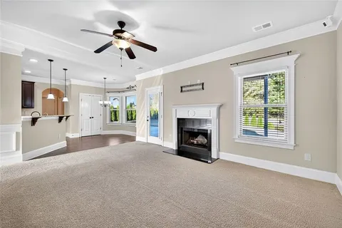 a view of an empty room with a fireplace and a window