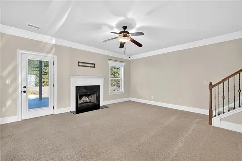 a view of a room with chandelier fan and fire place
