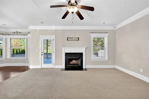 a view of an empty room with window and fire place
