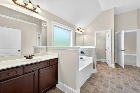 a spacious bathroom with a double vanity sink mirror double and shower