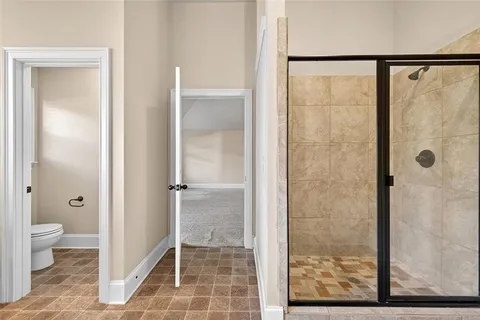 a bathroom with a glass shower door