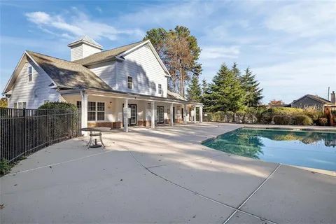 a view of a swimming pool with a yard