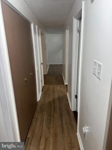 a kitchen with granite countertop a sink a stove and cabinets