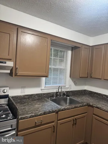an empty room with wooden floor and entrance
