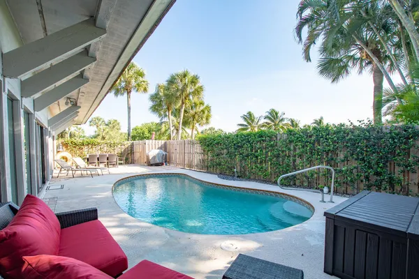 a view of a swimming pool in the backyard of a house