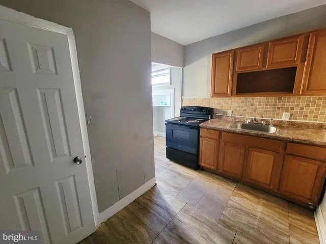 a kitchen with stainless steel appliances granite countertop a sink stove and microwave
