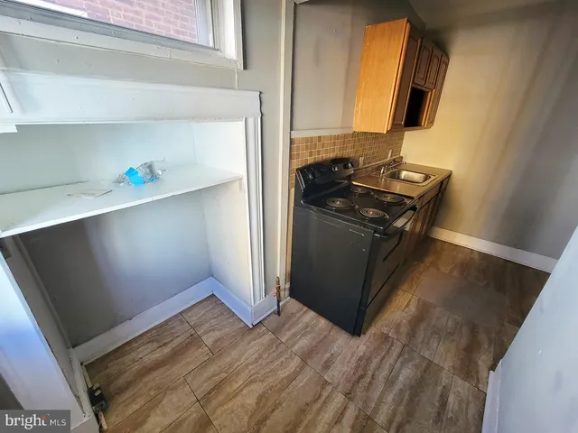 a kitchen with wooden floor and a sink