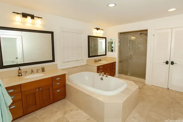 a bathroom with a tub sink and mirror