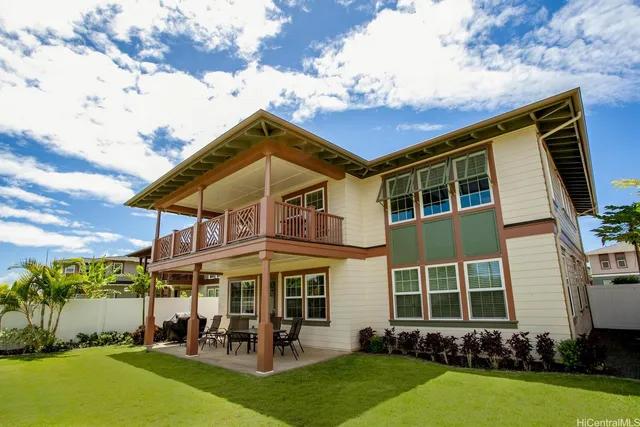 a group of people sitting in front of a house