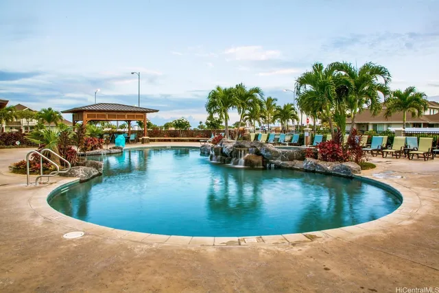 a view of a swimming pool with outdoor seating