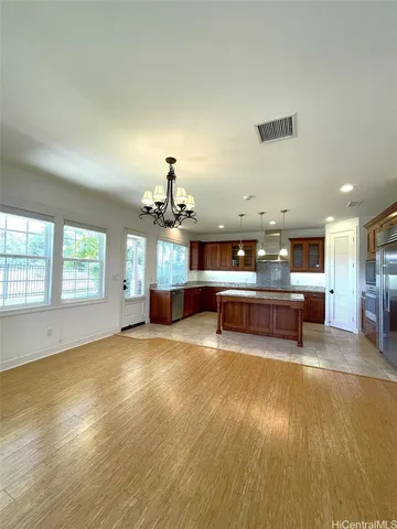 a living room with furniture and a kitchen